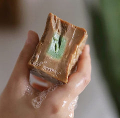 Alkawthar soap bars on wooden tray conveys handmade traditional production.