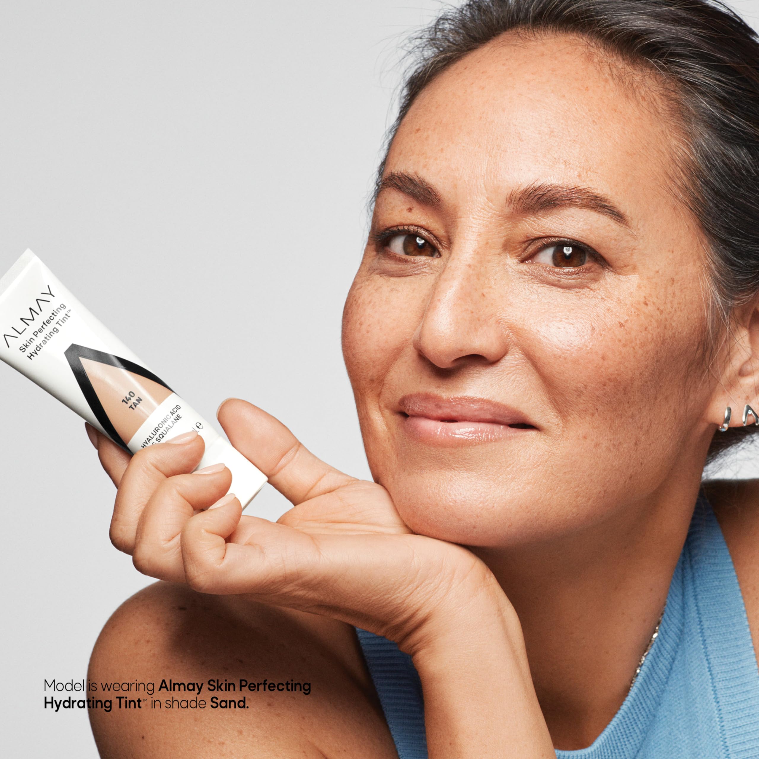 Almay Hydrating Tint applying to cheek for a dewy finish.