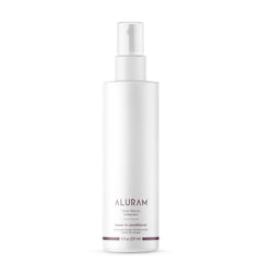 ALURAM Coconut Water Leave-In bottle closeup highlights instant hydration for healthy-looking hair.