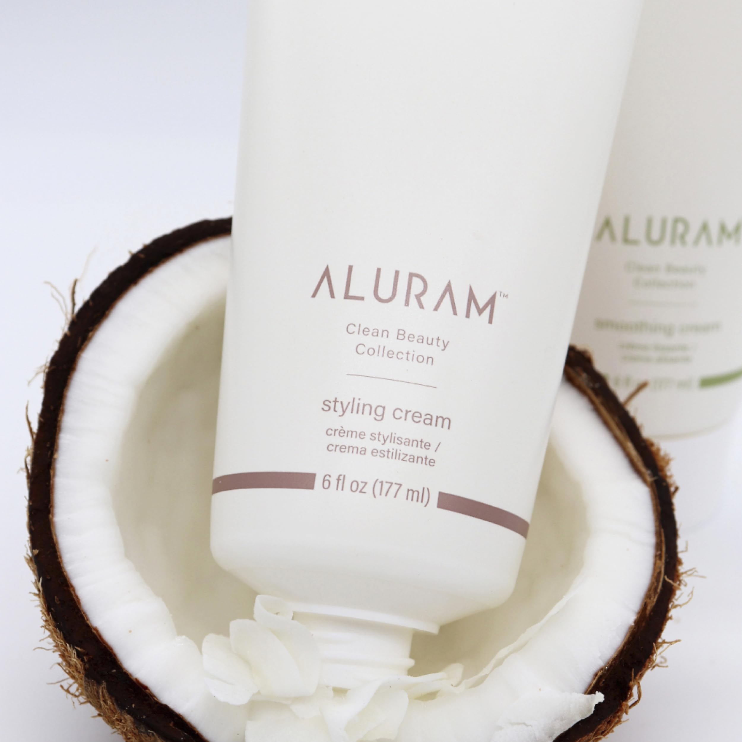 ALURAM Coconut Water Styling Cream hair definition on strand for sleek polish.