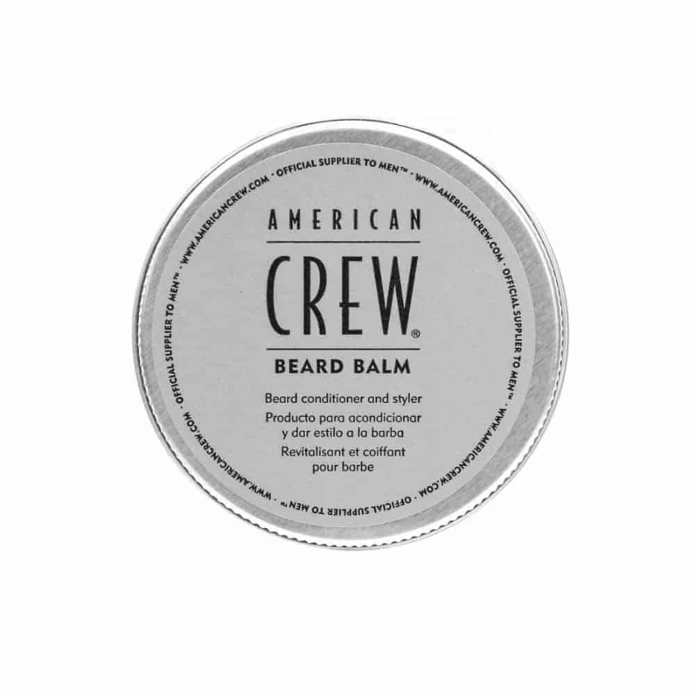 American Crew Beard Balm packaging on travel-friendly container for on-the-go grooming.