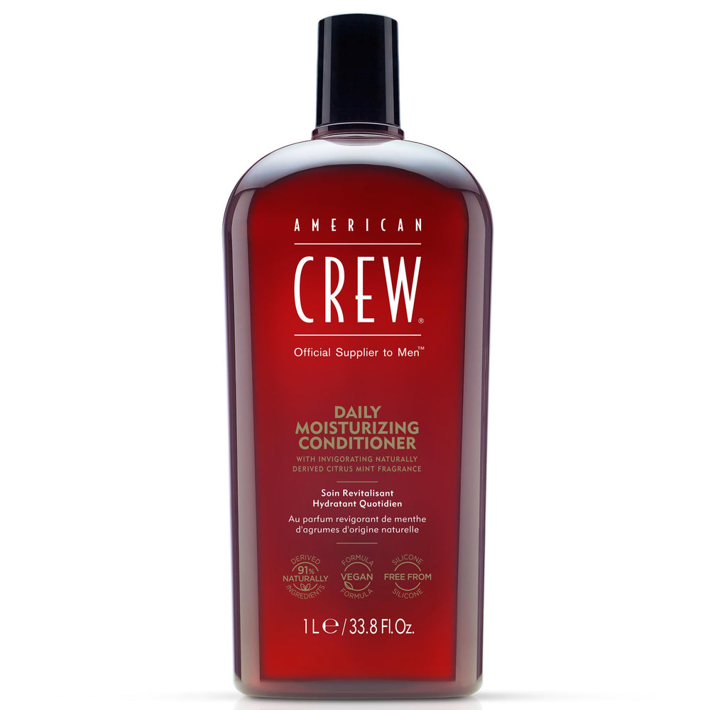 American Crew conditioner bottle pour demonstrates easy application and refreshing Citrus Mint fragrance for daily grooming.