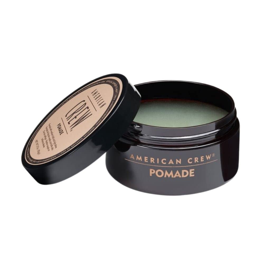 American Crew pomade demonstrates hold and shine during hair application for slick-back looks.