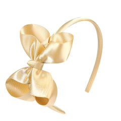 Amybasic gold metallic bow headband close-up for festive outfits.