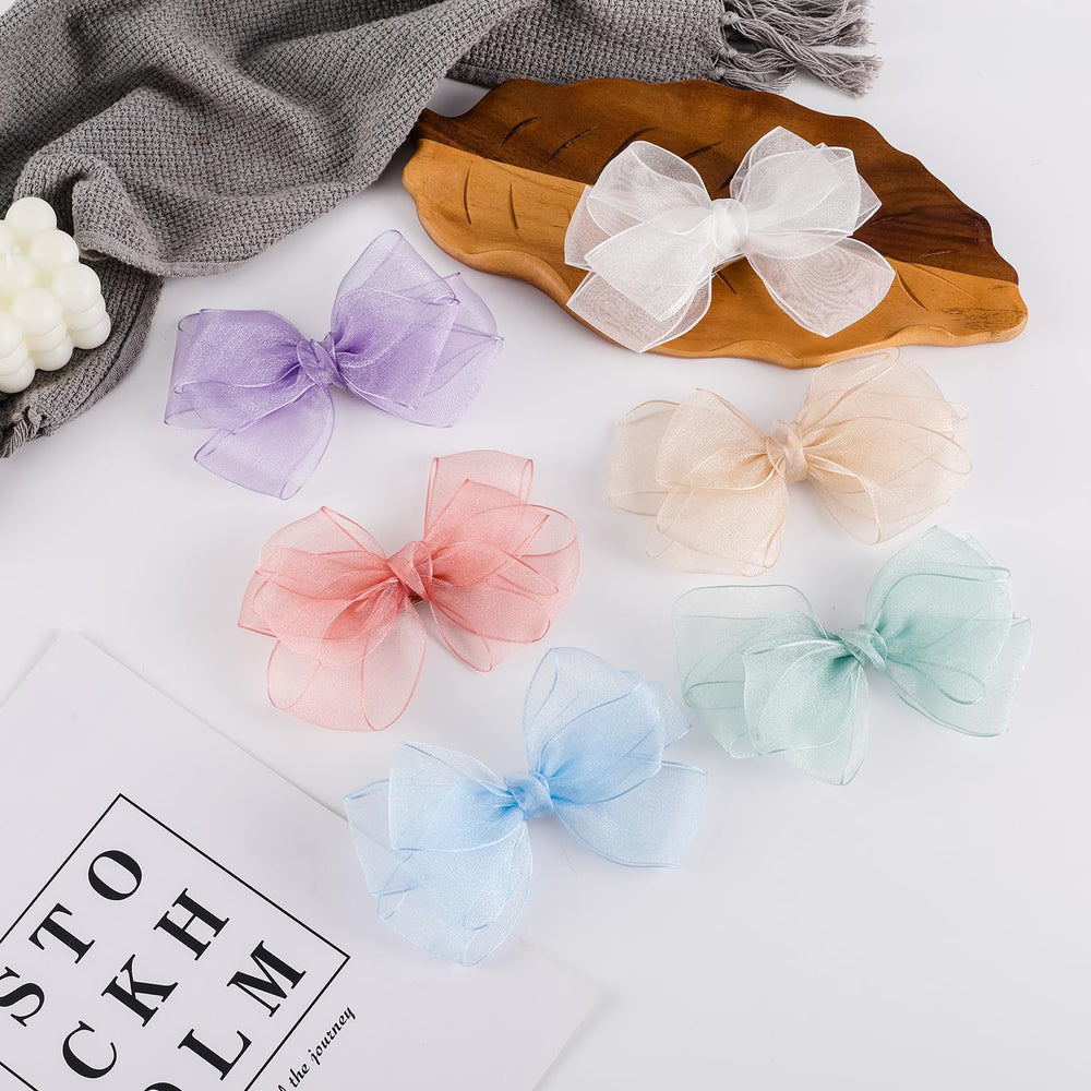 Amybasic lightweight white bow clip suited for all ages.