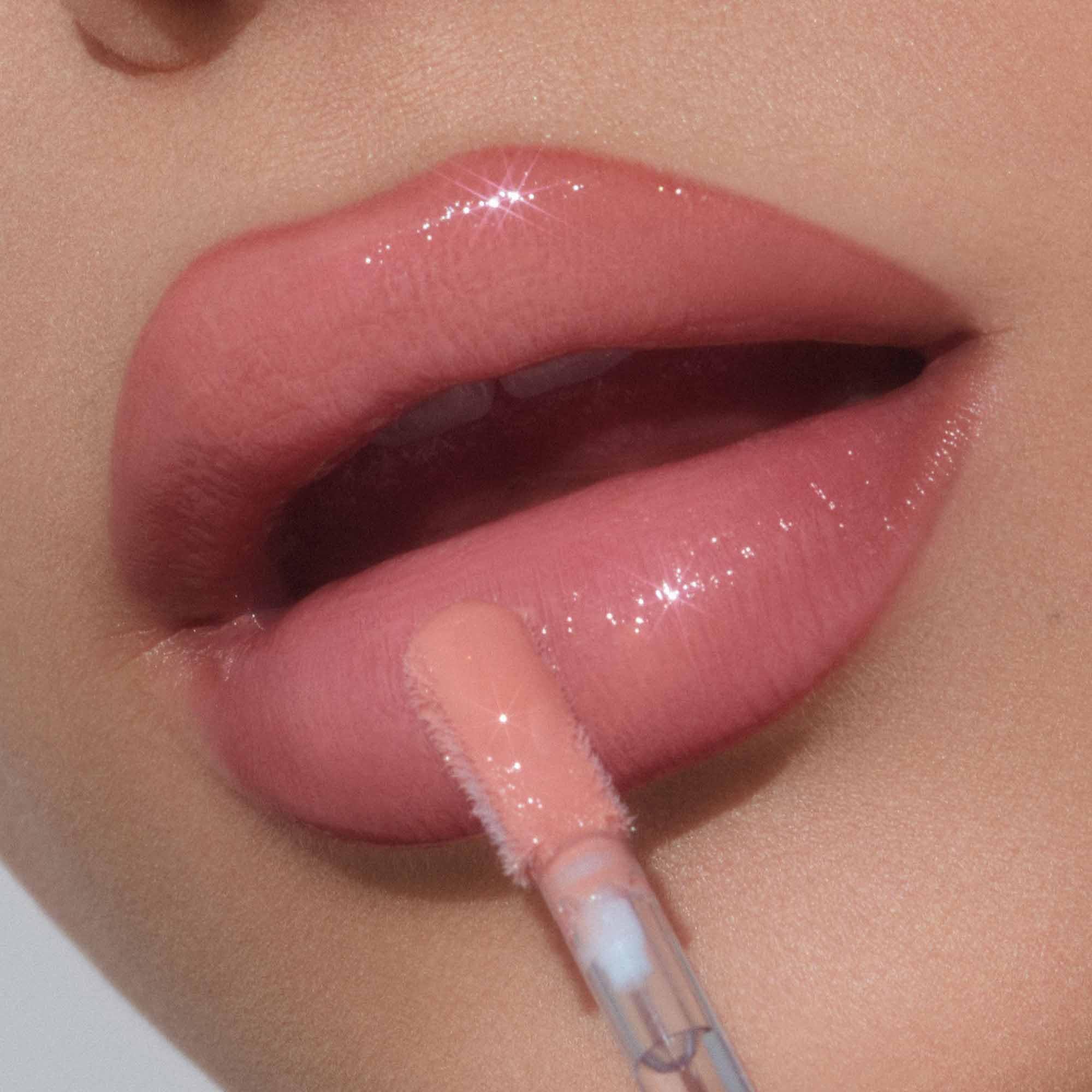 Tan Rose lip gloss on lips shows a fuller-looking effect