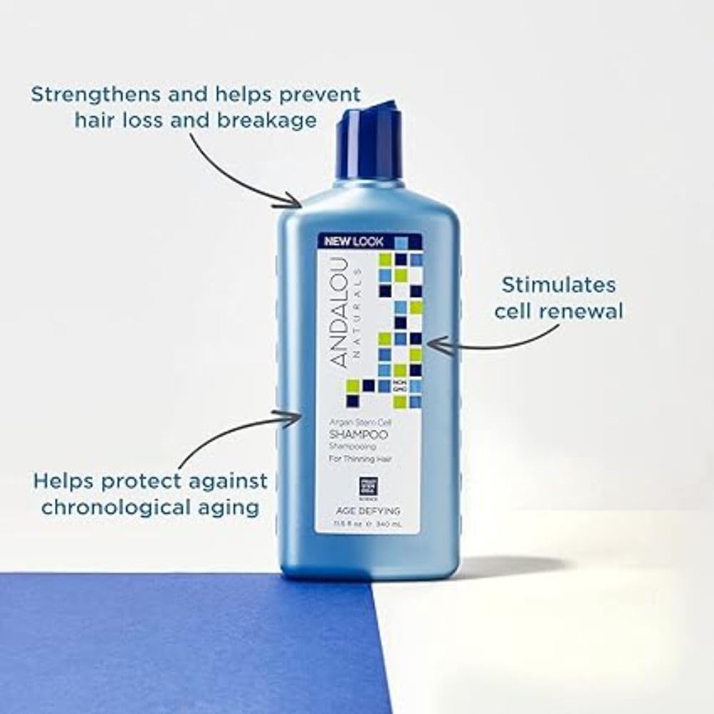 Andalou Naturals Argan Stem Cell Shampoo glass bottle on vanity showcasing shine potential.