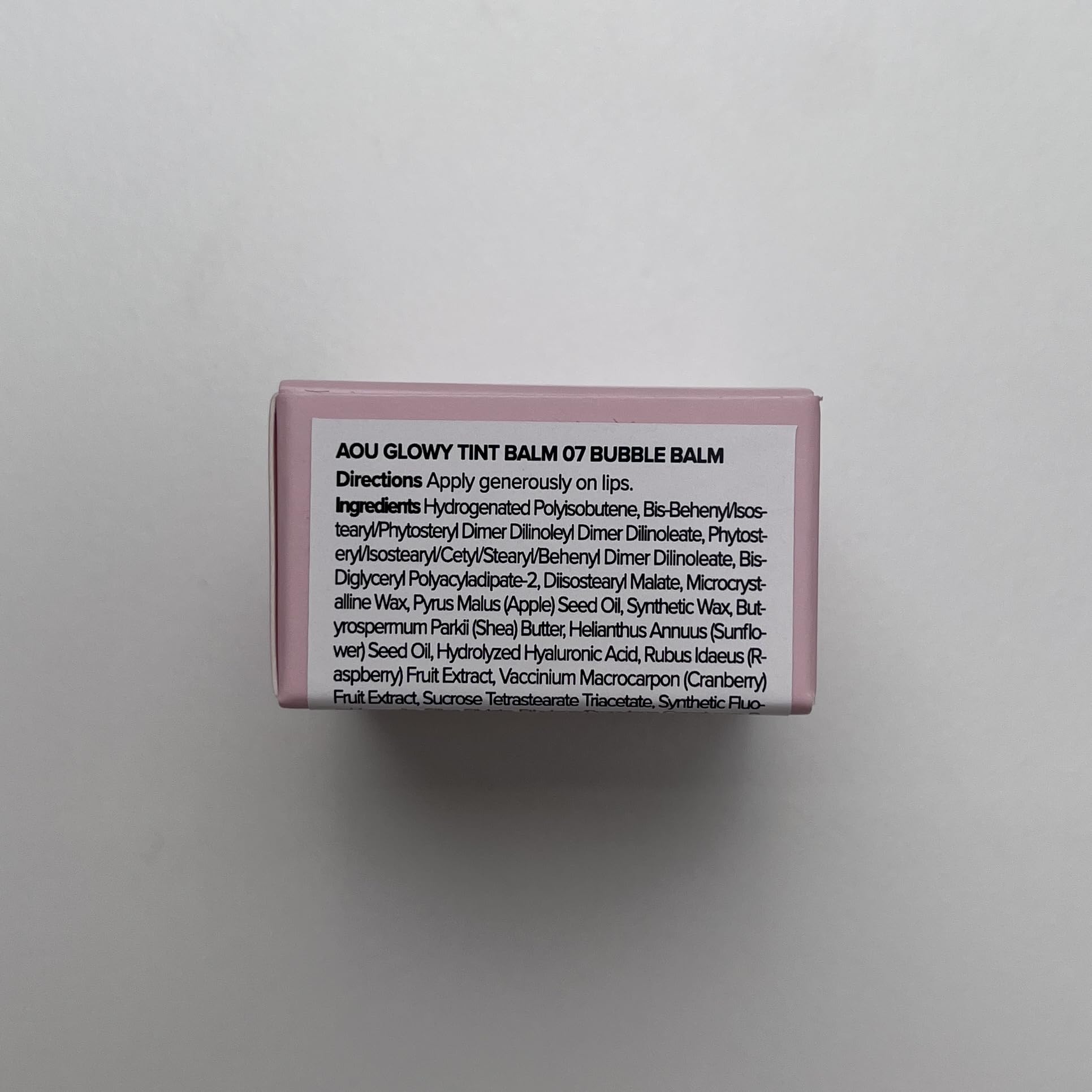 AOU GLOWY TINT BALM application on lips for daily color and moisture.