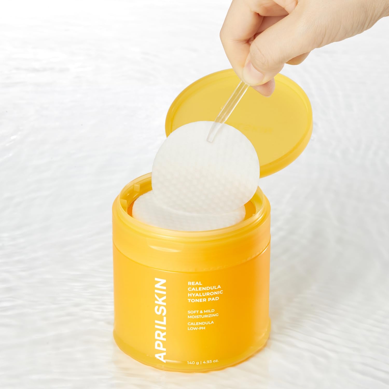 APRILSKIN Calendula PHA Hyaluronic Toner Pad close-up showing gentle exfoliation.