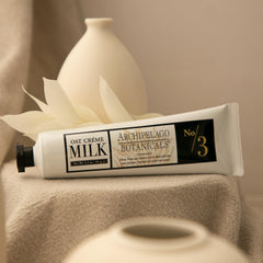 Archipelago Botanicals Oat Milk Hand Crème on dry hands demonstrates smoothing relief.
