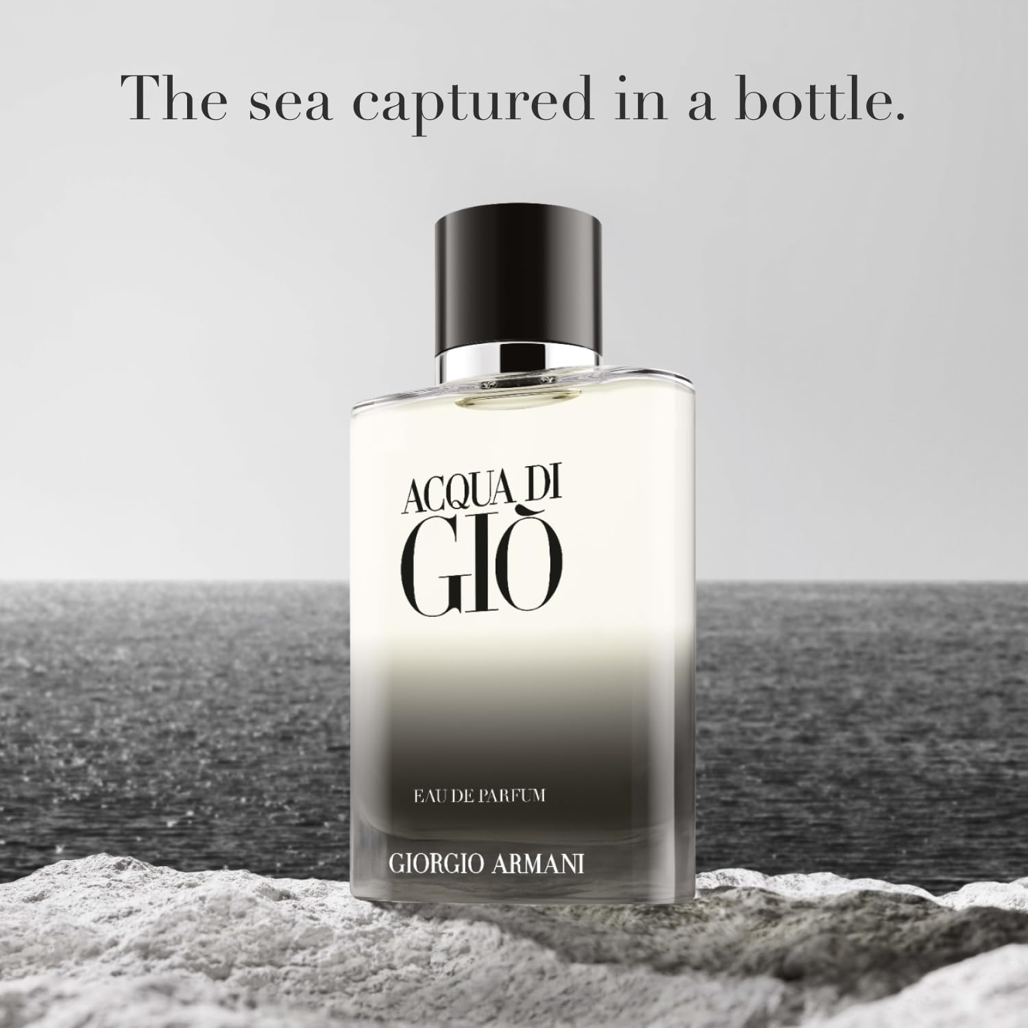 Armani Beauty Acqua di Giò bottle cap close-up emphasizes luxury grip and monogram detail for premium-at-hand experience.
