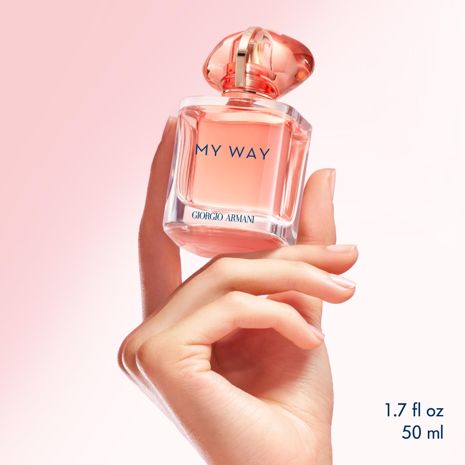 Armani Beauty My Way Ylang coral bottle on desk evokes an uplifting vibe.