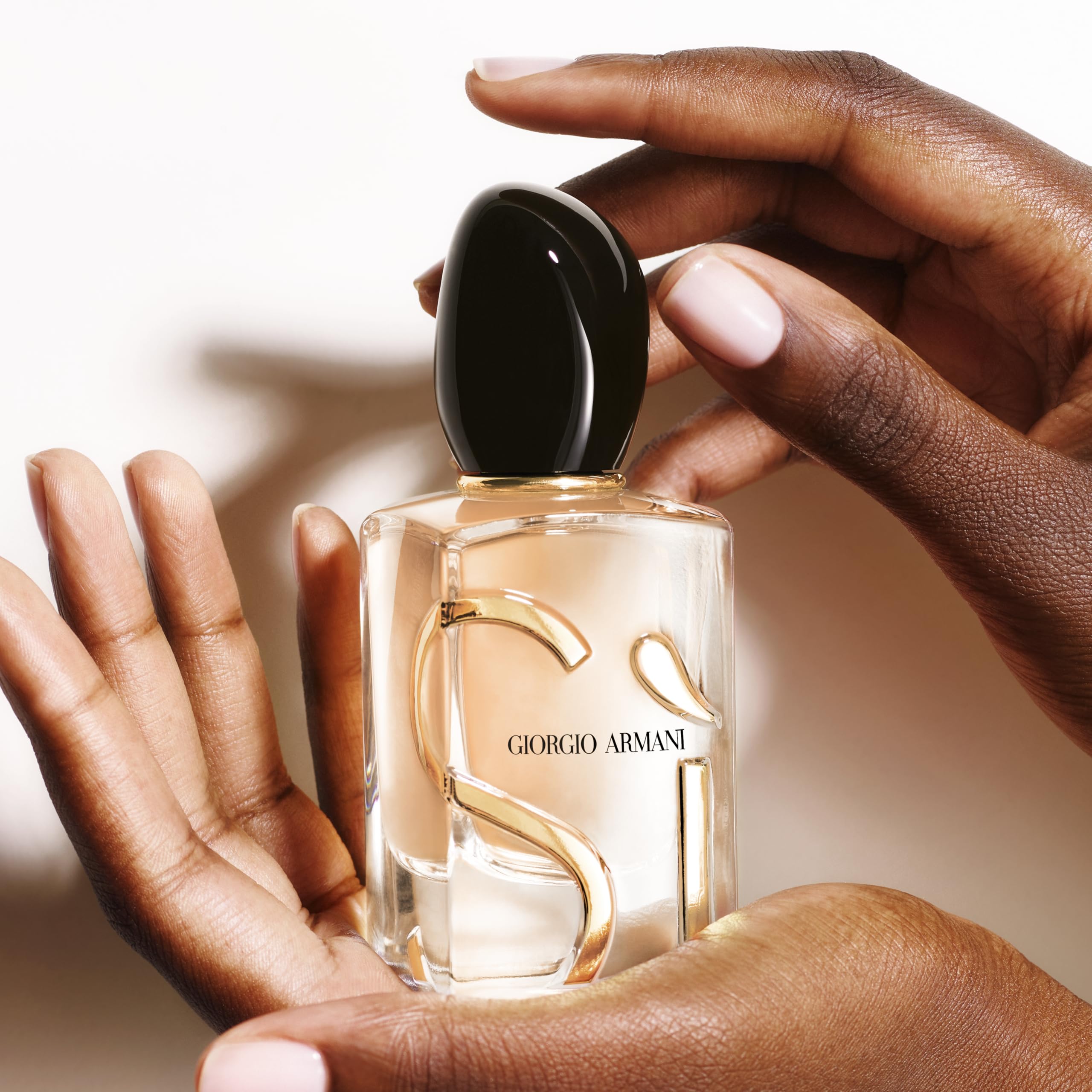 Woody patchouli base visible on label adding lasting depth for evening wear