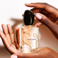 Woody patchouli base visible on label adding lasting depth for evening wear
