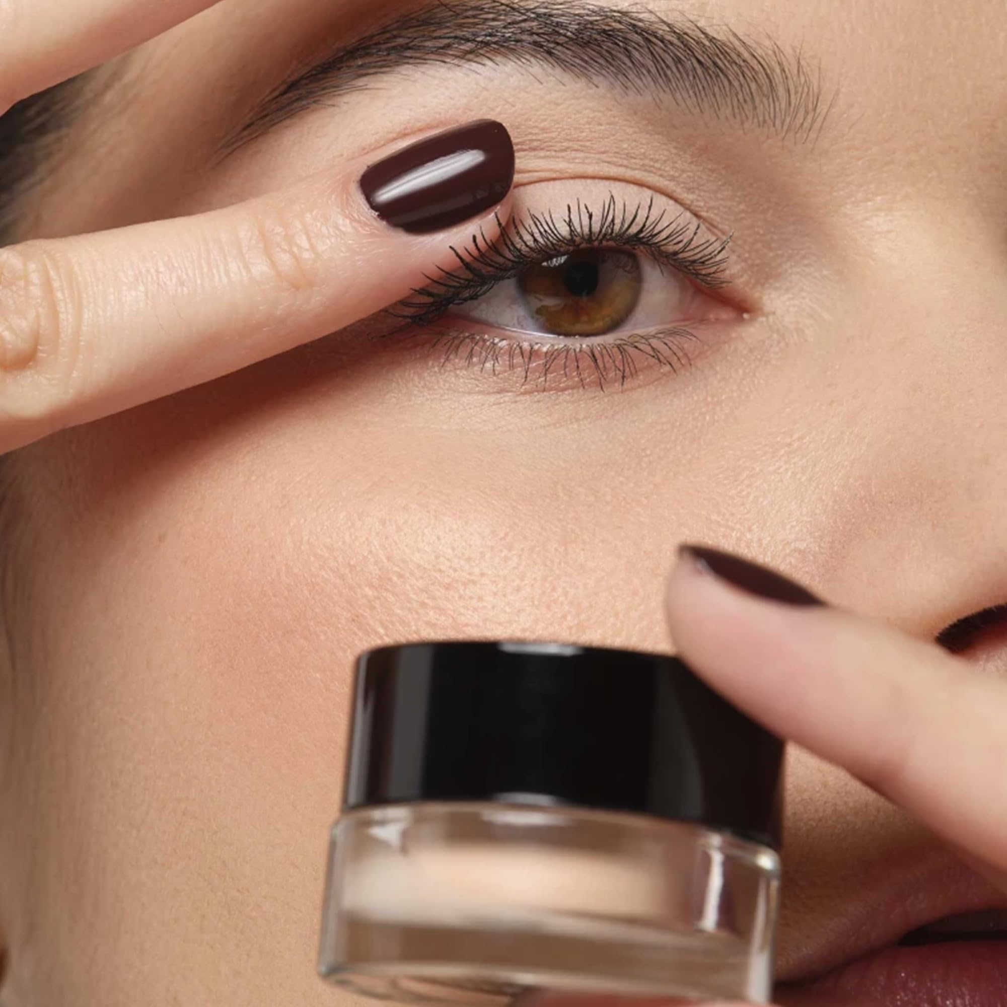 ARTDECO All In One Eye Primer application shot demonstrates precise coverage for redness concealment.