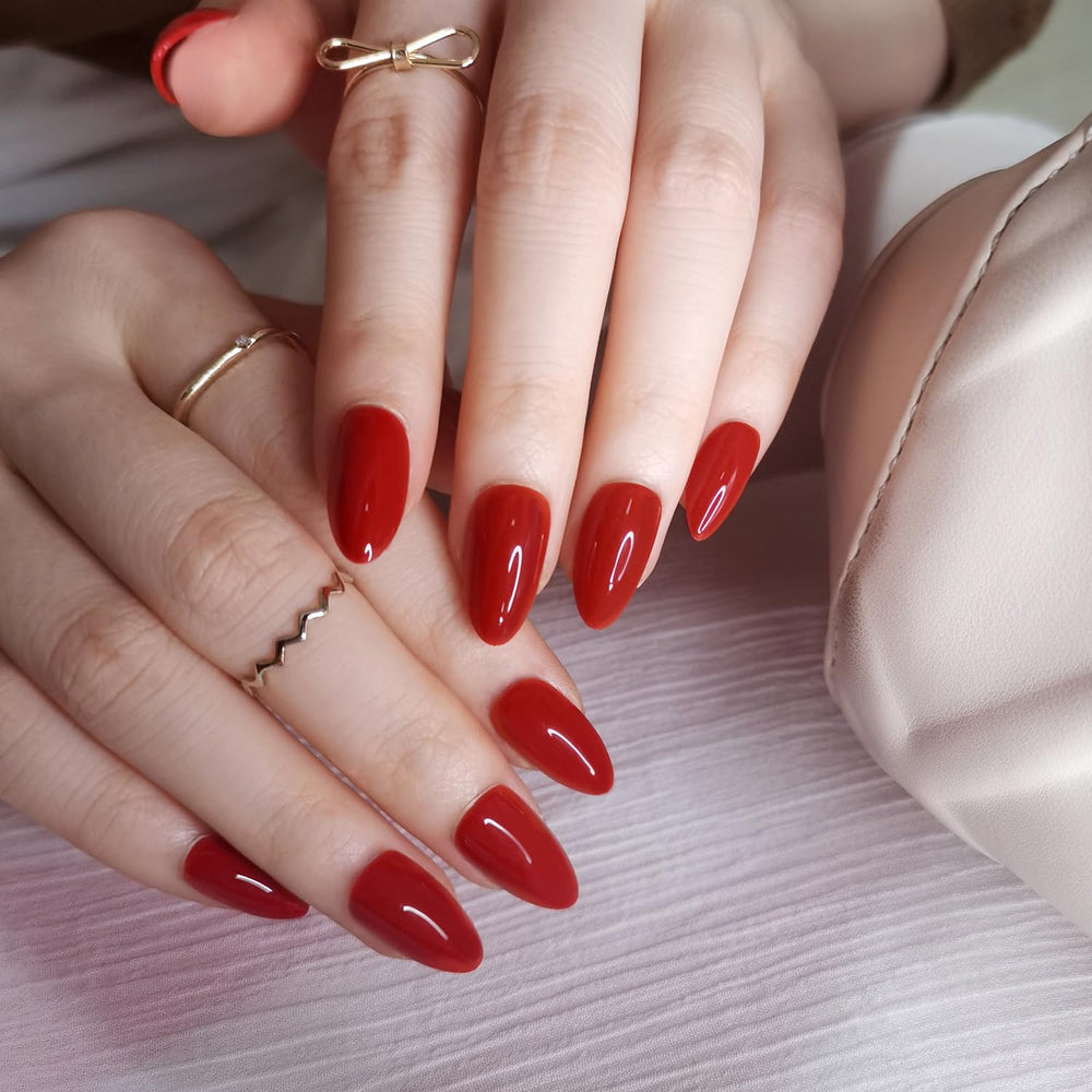 Artquee red almond nails close-up shows glossy finish for bold, lasting shine.