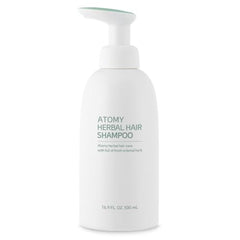 Atomy Herbal Hair Shampoo label closeup emphasizes natural extracts and cleansing.