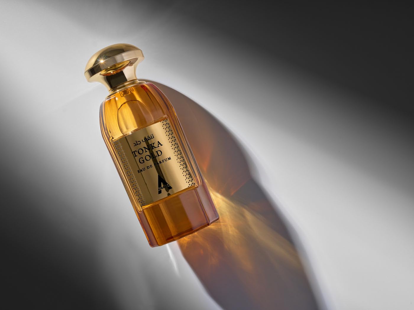Atralia Tonka Gold packaging with gold accents emphasizes premium fragrance presentation.
