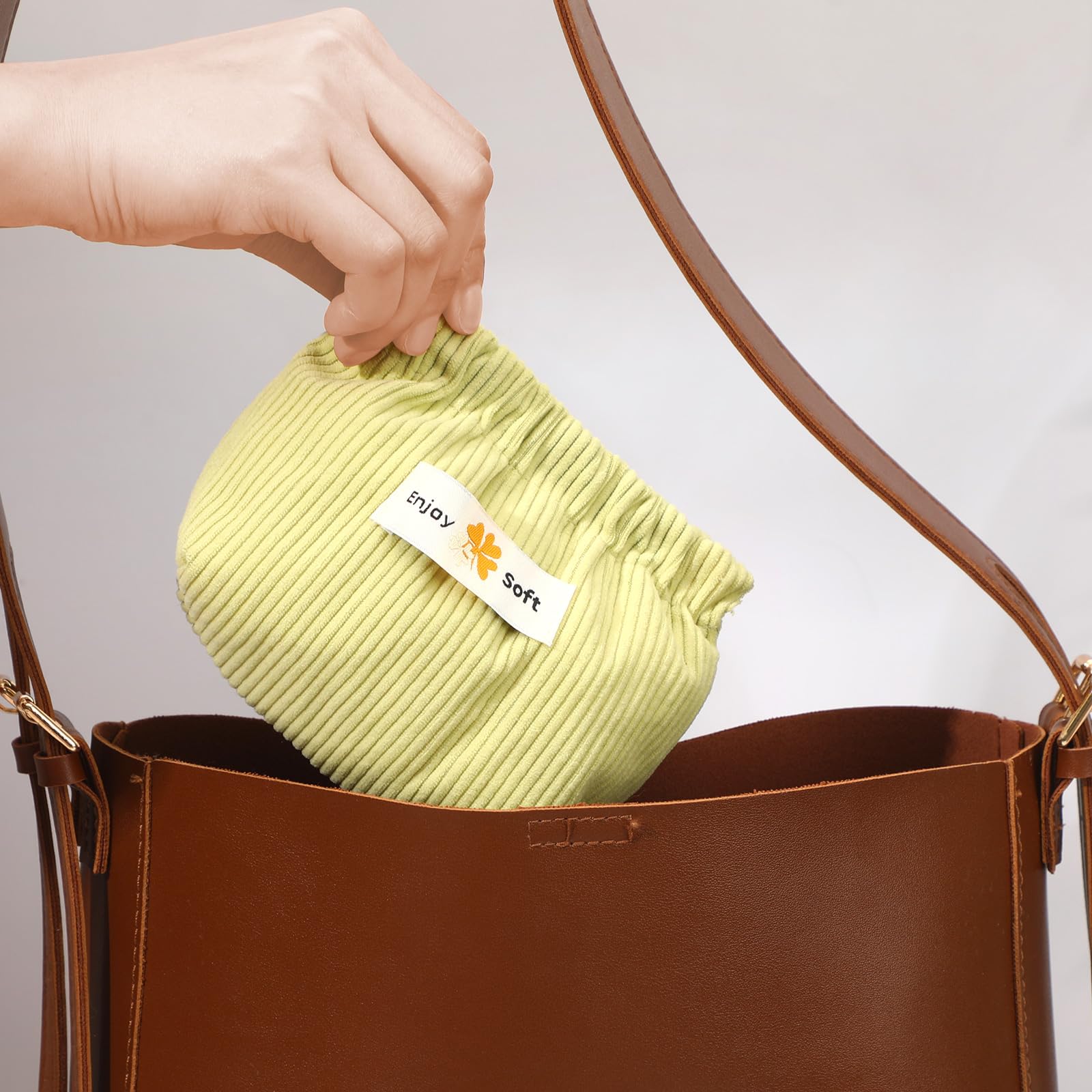 AUGSUN purple corduroy pouch organizes hair ties and earbuds.