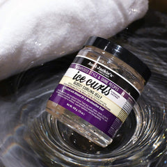 Aunt Jackie's Ice Curls glossy jelly in hand applying styling for soft definition.