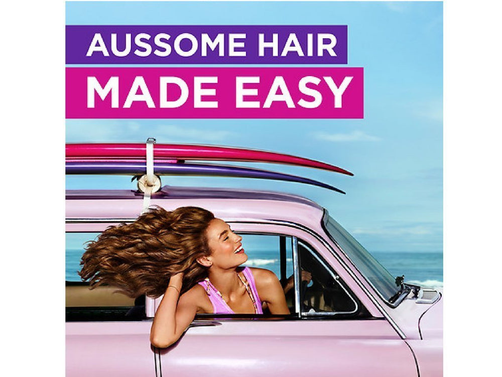 Aussie Miracle Moist conditioner close-up smoothing strands with citrus fragrance.