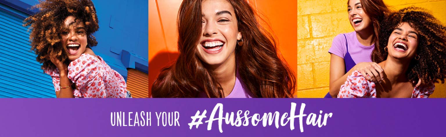 Aussie Miracle Moist shampoo close-up with foamy lather on hair.