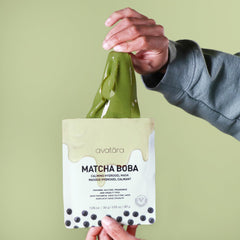 Avatara Matcha Boba Mask close-up with matcha leaves suggests antioxidant-rich nourishment.