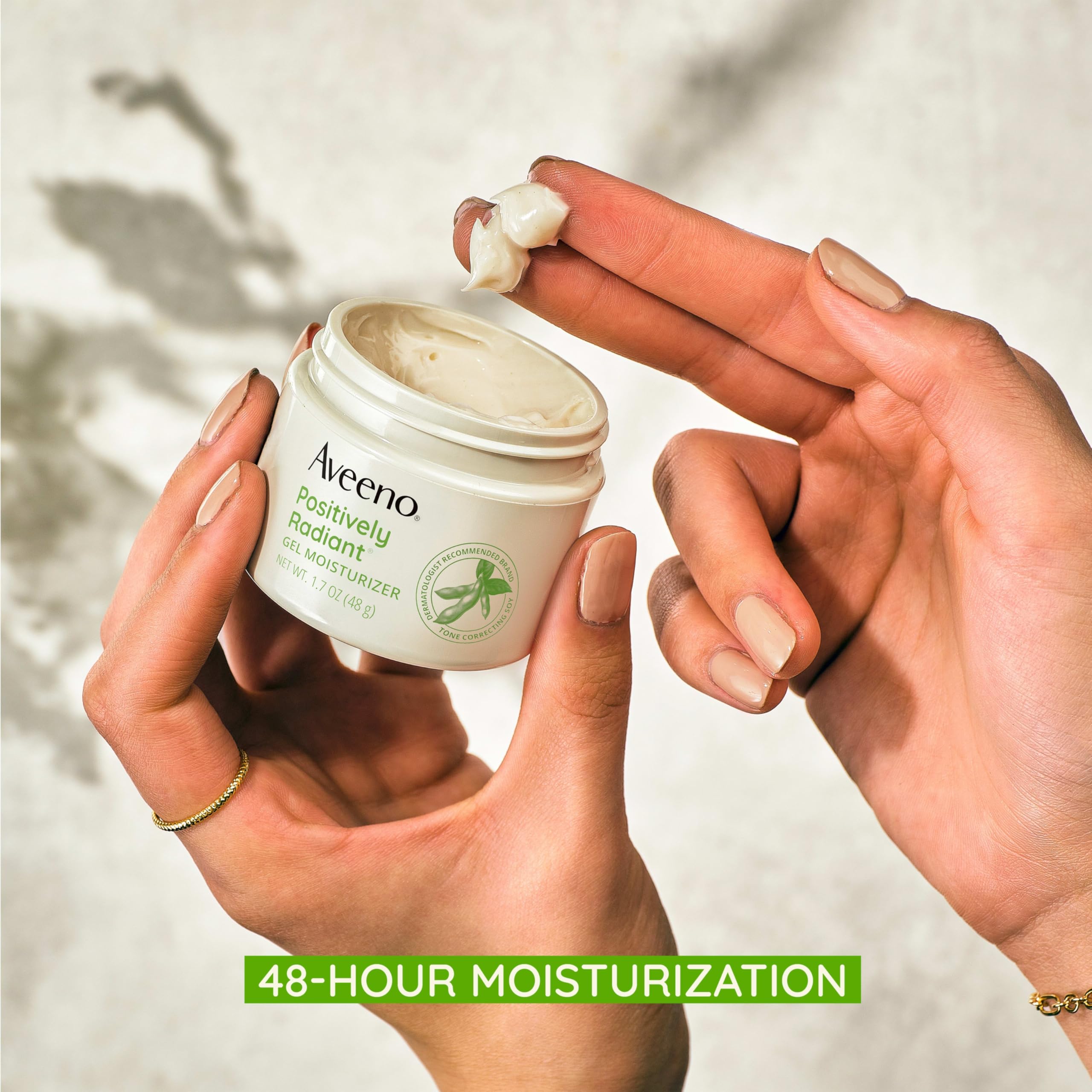 Aveeno Positively Radiant soy and hyaluronic acid component illustration emphasizes tone correction and moisturization