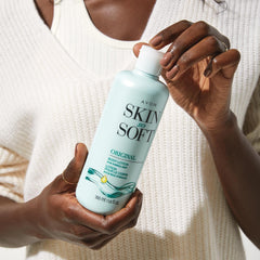 Hands applying Avon Skin So Soft Original for everyday softness.