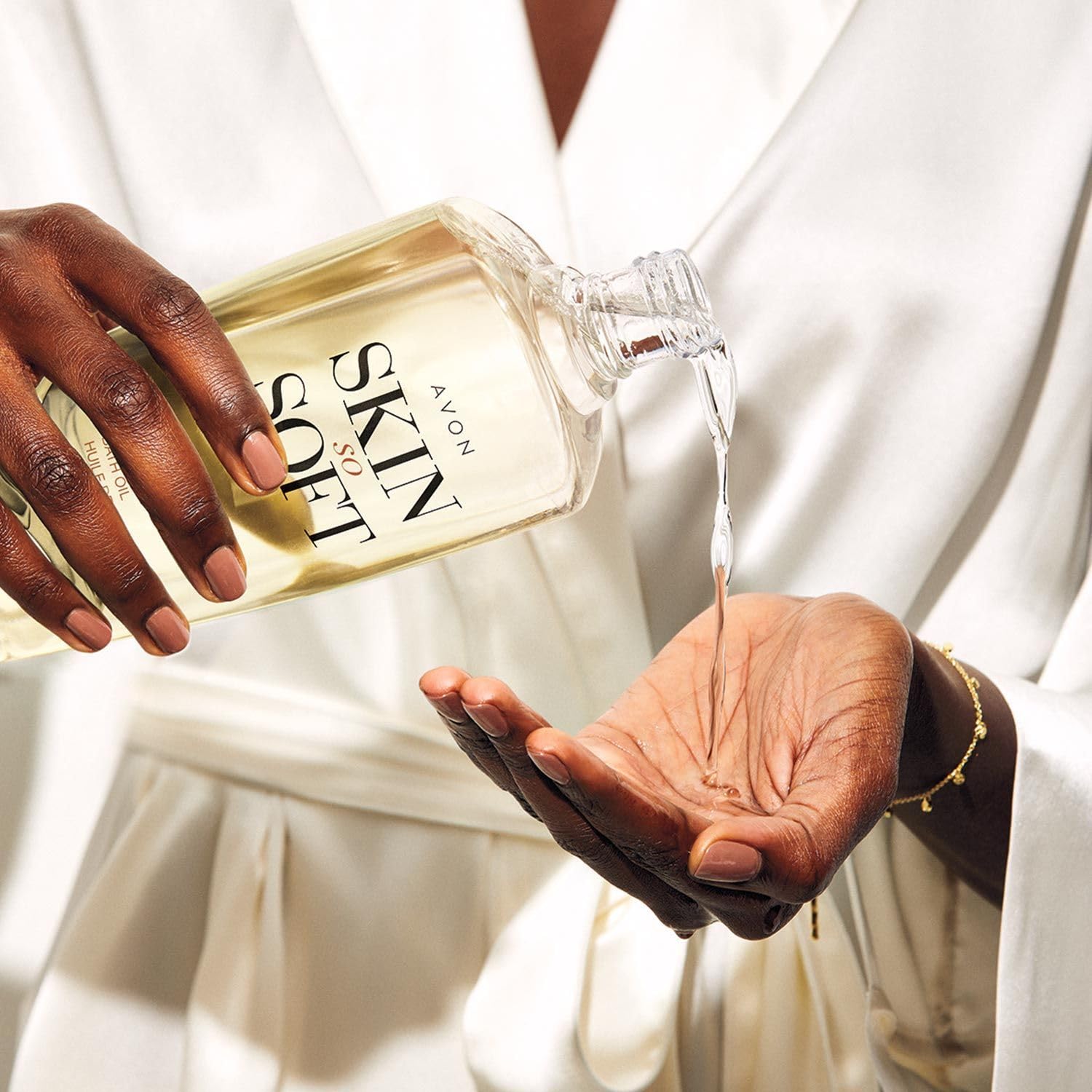 AVON Skin So Soft Radiant Moisture Bath Oil bottle close-up emphasizes hydration.