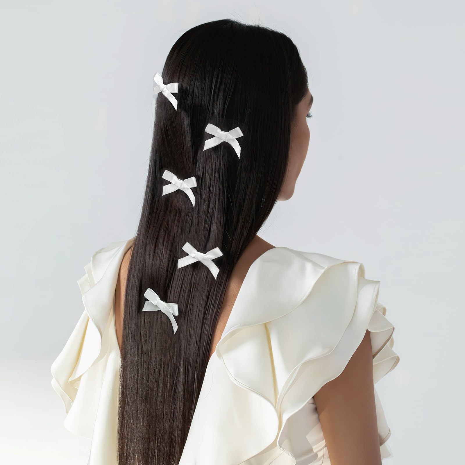Ayesha white mini bows clip-on style demonstrates secure all-day hold.