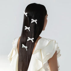 Ayesha white mini bows clip-on style demonstrates secure all-day hold.