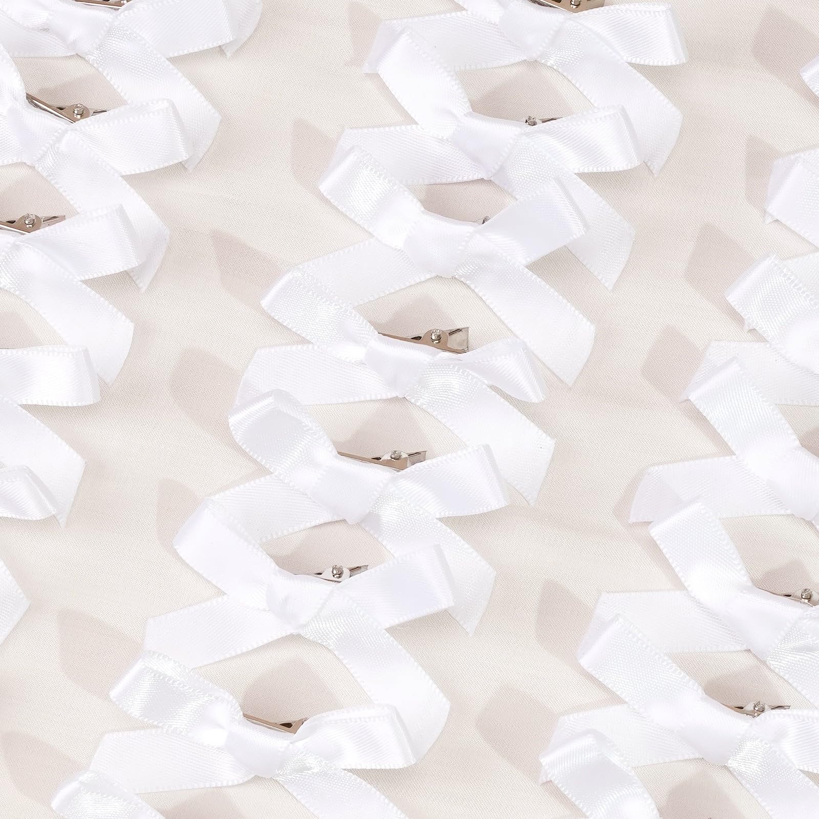 Ayesha white mini bows closeup highlights satin texture and precise stitching.