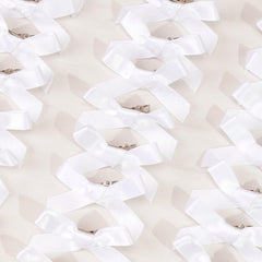 Ayesha white mini bows closeup highlights satin texture and precise stitching.
