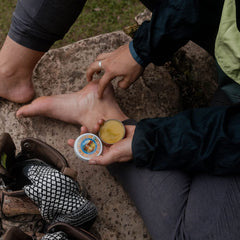 Badger Foot Balm olive castor jojoba oils image emphasizes organic blend for gentle hydration