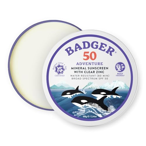 Badger reef-safe sunscreen tin on sunny beach for reef protection.