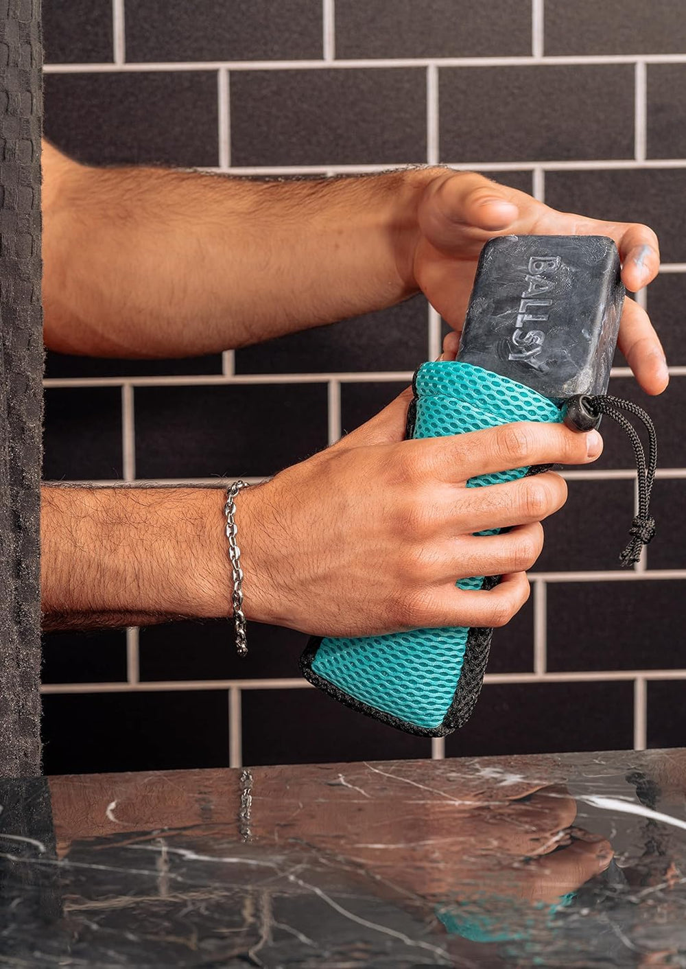 Ballsy Handy Shower Tool shown in a luxurious bath setting.