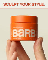 The Barb Shop pomade in hands demonstrates creamy texture for easy application and reworkable style.