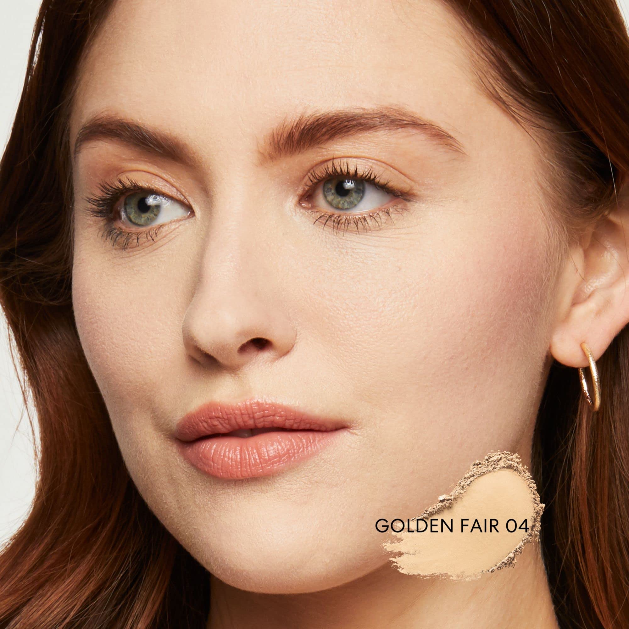 BareMinerals brush blending foundation on cheek for even coverage