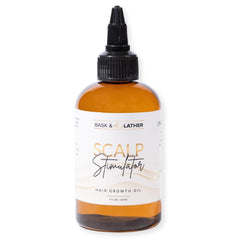 Bask & Lather scalp stimulator bottle close-up showing natural oils for growth support