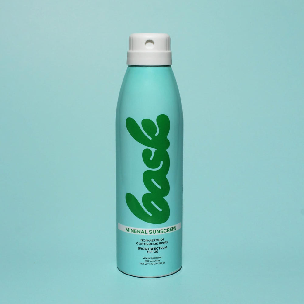 Bask Suncare fragrance-free spray demonstrates gentle application for sensitive skin.