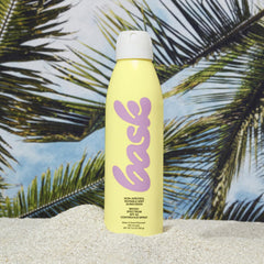 Bask Suncare SPF 50 spray demonstrates 360-degree application for easy reach.