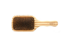 Bass The Green Brush bamboo handle close-up highlights bristles for gentle detangling.