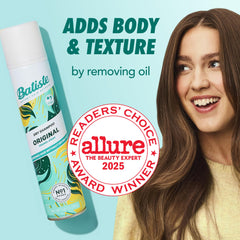 Batiste Original spray bottle in use, spraying at roots for lift