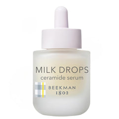 Beekman 1802 Milk Drops Serum bottle close-up for radiant hydration.