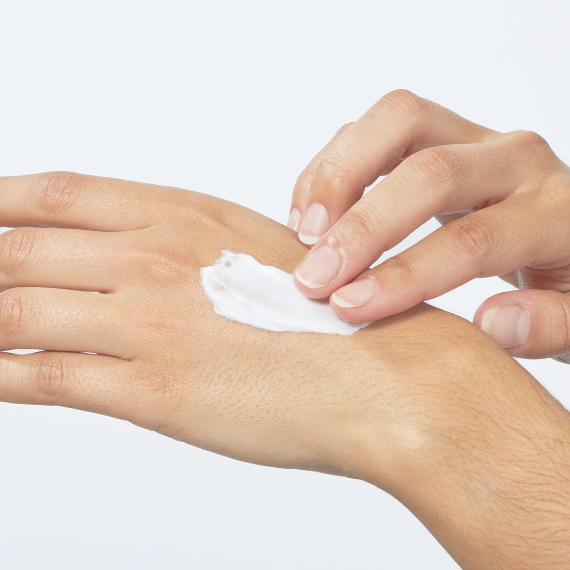 Beekman 1802 shea butter hydrates, softening dry hands in a creamy texture close-up.