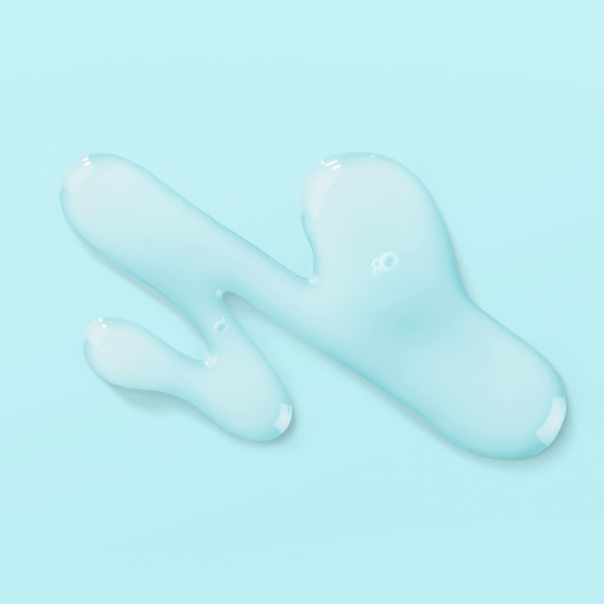 Glass Biossance bottle shown on skin with a dewy, healthy glow.
