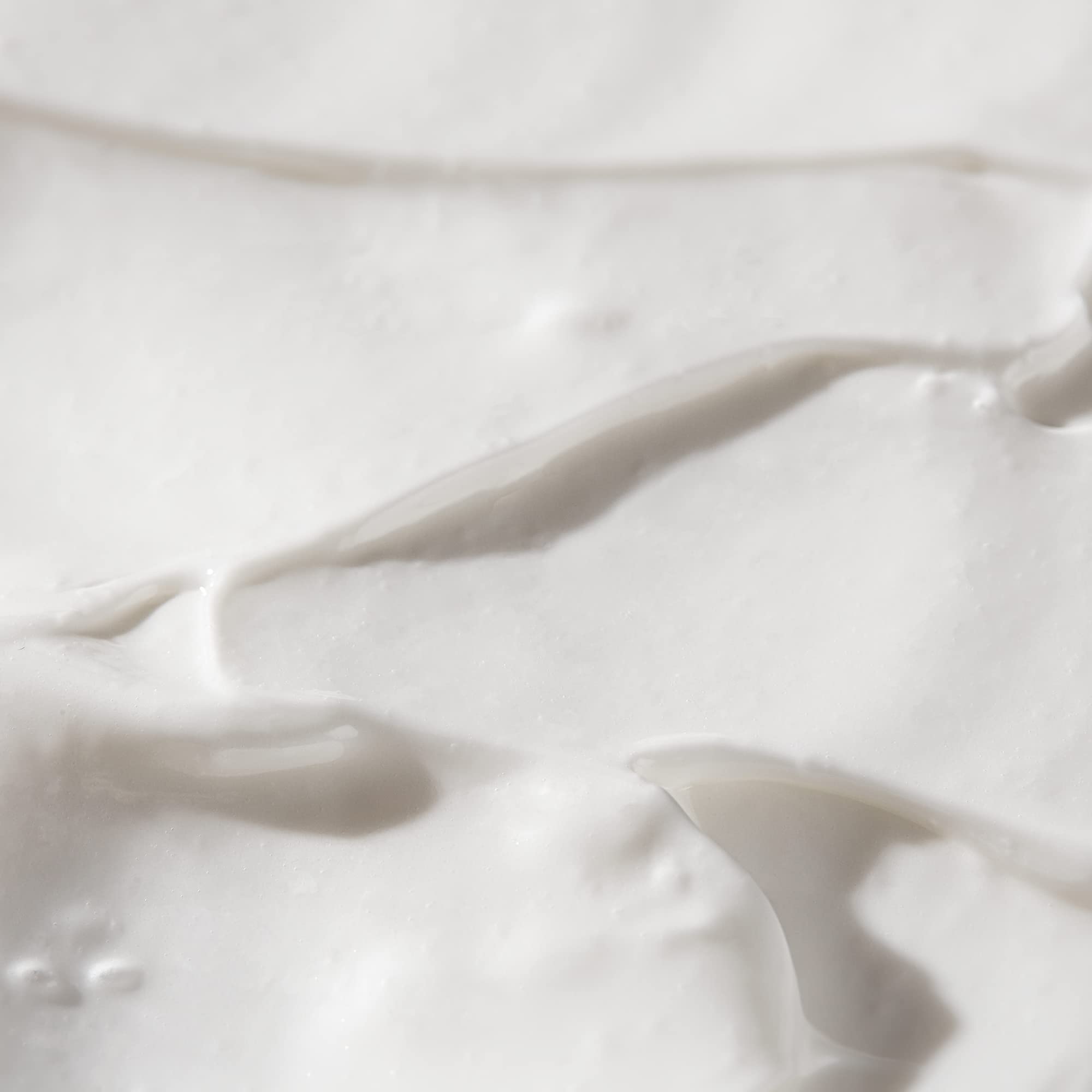 BIOSSANCE serum applied to neck and décolleté for texture refinement.