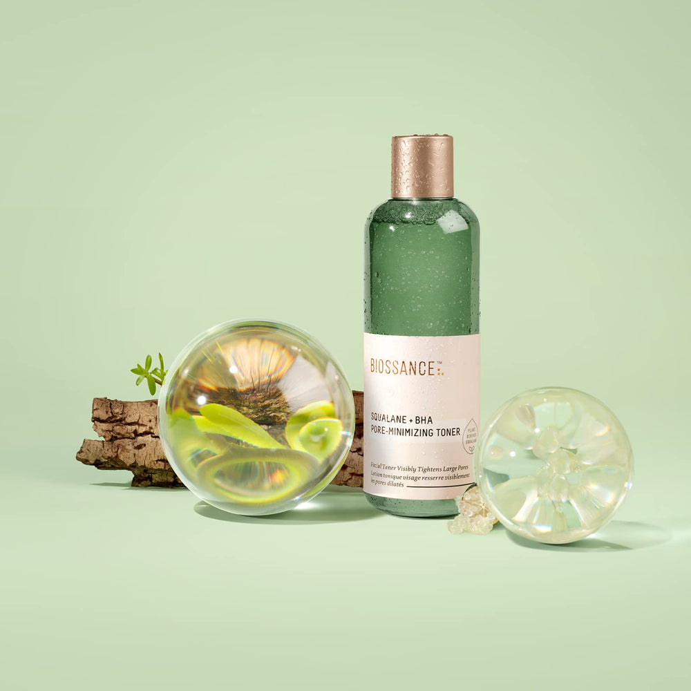 BIOSSANCE Squalane + BHA Toner bottle with splash emphasizes pore minimization.