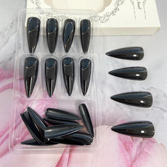 Black Solid Color Stiletto nails glossy finish close-up